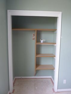 an empty closet with shelves in the corner and no doors or drawers on either side