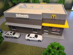 a mcdonald's restaurant with cars parked in front