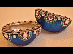 two blue vases sitting on top of a table