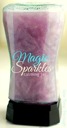 a candle that is sitting on top of a table with the words magic sparkles