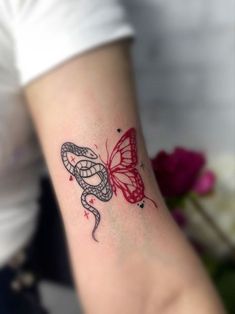 a woman's arm with a tattoo on it and a butterfly in the middle