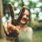 a woman making the peace sign with her fingers