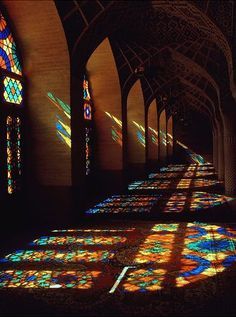 the sun is shining through stained glass windows