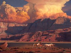 two horses are standing in the desert with mountains and clouds behind them, as the sun sets