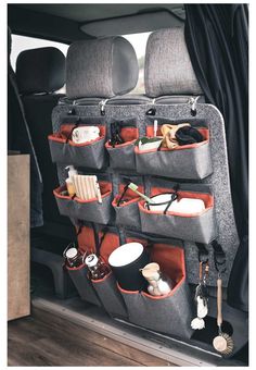 an open car trunk with various items in it and hanging on the back wall,