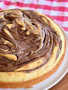 a close up of a cake on a plate with chocolate frosting in the middle