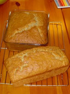 two loafs of bread sitting on top of a metal rack