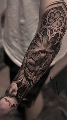 a man's arm with an intricate tattoo design on the forearm and hand,