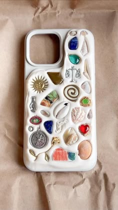 a cell phone case with various sea shells and seashells on the back cover