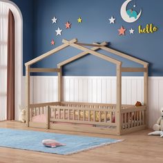 a child's bedroom with blue walls and stars on the wall, including a bed frame