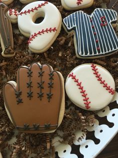 decorated cookies in the shape of baseballs and mitts