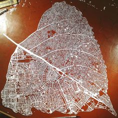 a drawing of a city map on top of a wooden table