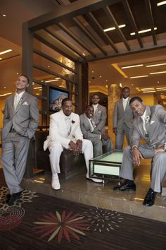 a group of men in suits posing for a photo