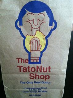 a paper bag with the logo of the tatonnut shop on it's front