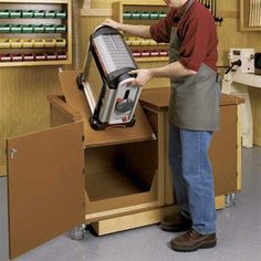 a man standing next to a machine in a room