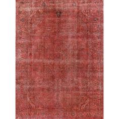 an antique rug with faded red colors