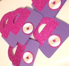 some purple and pink paper cut out to look like letters