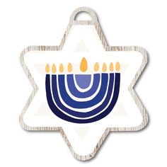 a hanukkah star shaped ornament with candles on it's side