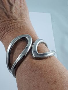 "This is a nice chunky hinged Sterling Silver cuff. SKU-330  Its simple design is easy to wear and live with every day.  Although the cuff is 8\" around the wrist, it can be worn up the arm comfortably if you have a small wrist. The hinge mechanism makes it easy to open the cuff and slip it on.  This cuff is solid, and has a nice weight to it. D E T A I L S: Measures approx. 8.0 inches long x 2.5\" wide. Weighs approx. 57.9 grams Hallmark: Stamped \"925 \"inside the cuff Condition: Very good vin Adjustable Contemporary Cuff Bracelet, Modern Metal Wide Band Bracelets, Modern Wide Band Metal Bracelet, Arm Cuff, Dainty Bracelets, Sterling Silver Cuff, Professional Cleaning, Silver Cuff, I'm Happy