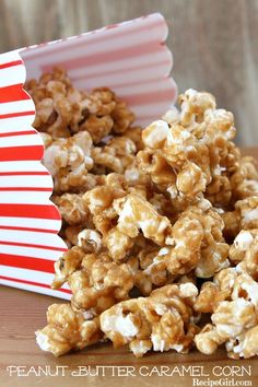 a pile of popcorn sitting on top of a table next to a red and white striped box