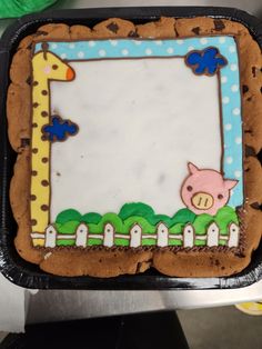 there is a cake decorated like a giraffe and a pig on the side