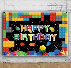 a birthday card with legos and confetti on the wall in an empty room