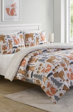 the comforter is made up with animals on it