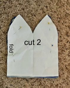 an origami cut 2 piece of paper with the words cut 2 on it