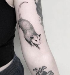 a woman's arm with an animal tattoo on the left side of her arm