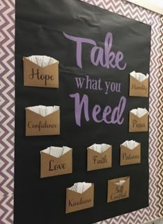 a bulletin board that says take what you need with some paper bags attached to it