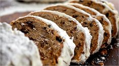 several pieces of cake sitting on top of a cutting board covered in powdered sugar