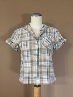 Authentic vintage short sleeve shirt. Has collar with full button up front. Dates from late 80's to early 90's. Classic plaid design. Soft cotton blend. Shorter cropped style. This shirt is in great condition with little to average signs of previous use. Still has many years of wear left. Check out my shop 'TheBarnLadder' for reviews and feedback All items are free of rips, tears, holes, and stains. Vintage items are subject to signs of previous wear. Purchase Policy All vintage items are non re Casual 1980s Outfits, Late 80s Early 90s Fashion, Cute 80s Outfits, 80s Tops, Early 90s Fashion, 1980s Outfits, Short Sleeve Plaid Shirt, 80s Clothes, 90s Blouse