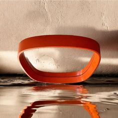 an orange object sitting on top of a shiny surface