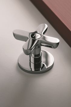 a chrome faucet on a white counter top