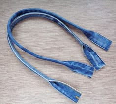 a pair of blue jeans tied together on a table