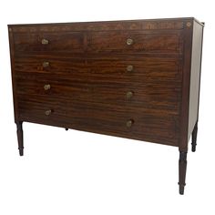 an antique chest of drawers with brass pulls and knobs on the top, against a white background