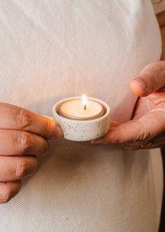 a person holding a candle in their hands