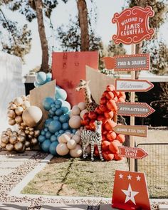 there is a sign that says welcome to carnival and balloons in the shape of giraffes