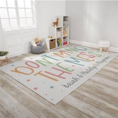 a child's playroom with toys and rugs on the floor that says welcome home