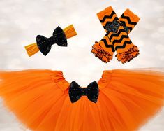 an orange tutu skirt with black bows and chevrons