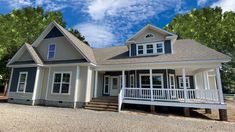 a white house sitting on top of a gravel road