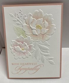 a close up of a card with flowers on it and the words sympathy written in gold