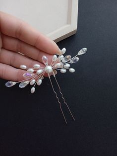 Elevate your bridal look with our exquisite crystal rhinestone and pearl wedding hair pin. This versatile accessory is designed to complement ANY hairstyle, adding a touch of glamour to your special day. * Stunning crystal rhinestones and lustrous pearls create a timeless and sophisticated look. * Versatility that enhances any hairstyle, ensuring you look your best from every angle. * Approximately 4 inches wide for a statement-making yet delicate finishing touch. Make your wedding day unforgettable with this elegant bridal hair pin. Order now to add a touch of sparkle and sophistication to your bridal ensemble! * All orders from the Exclusive Wedding Shop you will receive in a FREE beautiful gift box. * Standard shipping: - USA: 12-15 business days - Europe: 3-5 weeks - Canada: 6-10 weeks Elegant Pearl Bridal Accessories In Silver, Hair Pieces For Wedding, Wedding Hair Pieces Pearl, Wedding Hair Jewelry Brides & Hairpins, Adjustable Crystal Embellished Hair Accessories For Weddings, Crystal And Pearl Bridal Headpiece, Pearl Hair Pin Wedding, Bridal Hair Pins Pearl, Diy Hair Accessories Ribbon