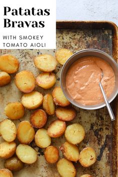 baked potato wedges with smoky tomato aioli sauce on a baking sheet, ready to be eaten