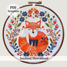 an embroidery kit with the instructions for how to make a fox and floral wreath on it