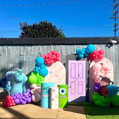 an outside area with balloons, toys and decorations