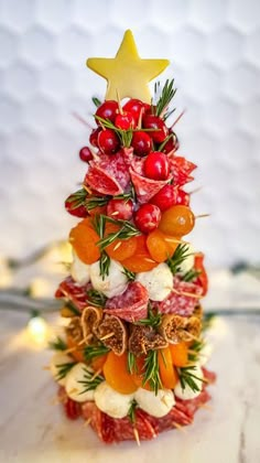 a small christmas tree made out of fruits and veggies with a star on top