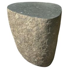 a large gray rock sitting on top of a white background