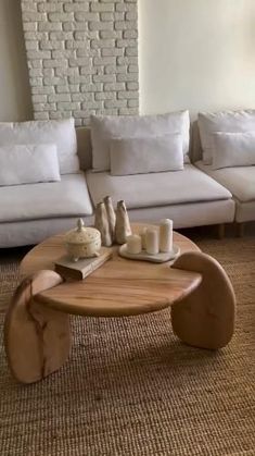 a living room with white couches and coffee table in it's center area