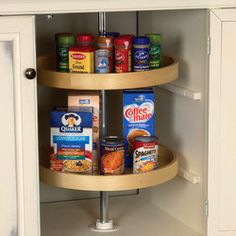 two tiered spice rack in the corner of a cupboard